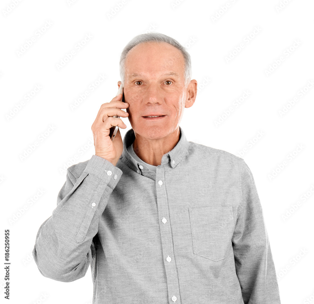 Attractive mature man talking on phone against white background Attractive mature man talking on phone against white background
