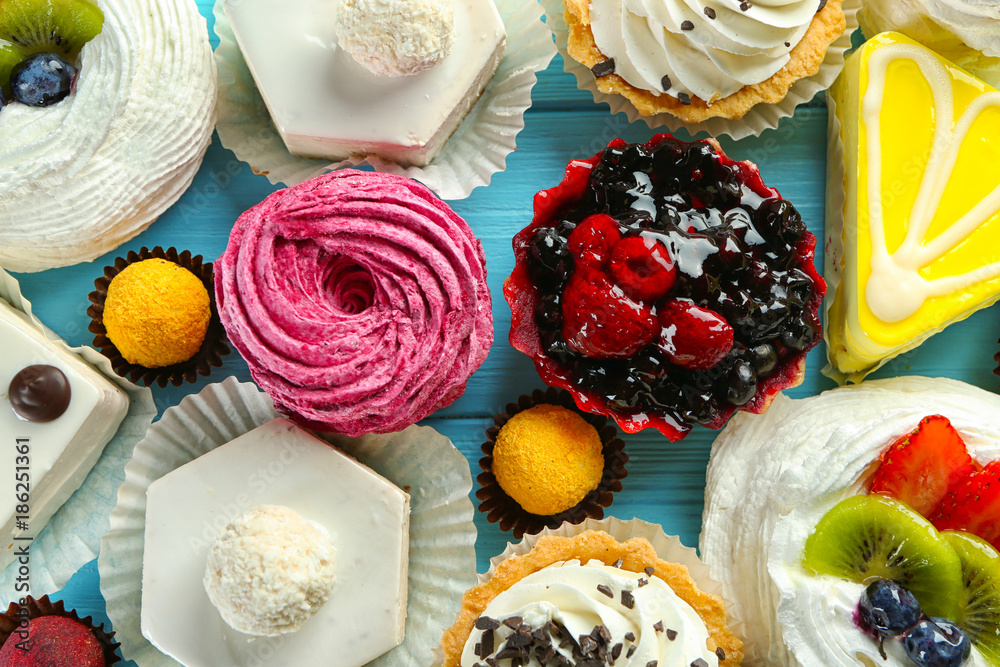Assortment of tasty sweets on wooden background Assortment of tasty sweets on wooden background