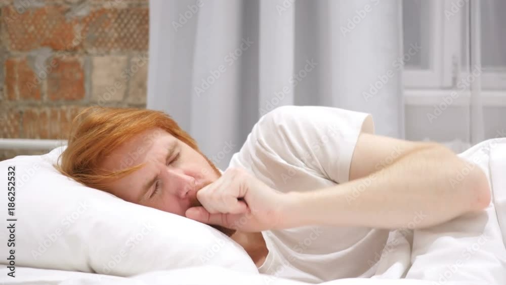 Coughing Sick Man in Bed at Night, Throat Infection, Lying on Side Coughing Sick Man in Bed at Night, Throat Infection, Lying on Side