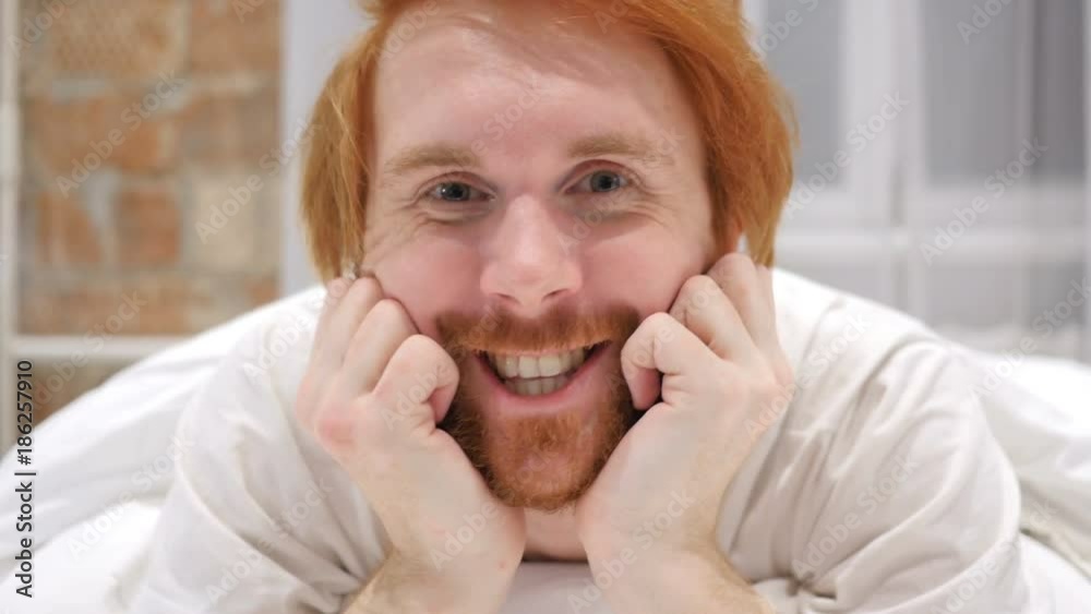 Video Chat on Laptop by Redhead Beard Man in Bed at Night Video Chat on Laptop by Redhead Beard Man in Bed at Night