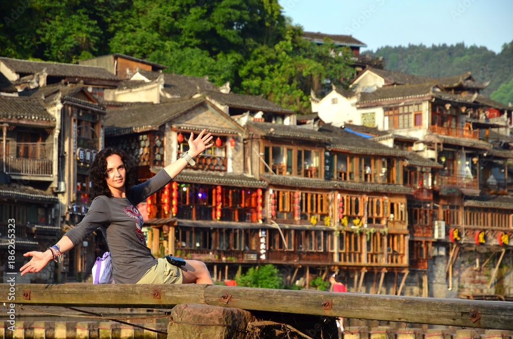 Women at riverside on the Phoenix Hong Bridge in Fenghuang Women at riverside on the Phoenix Hong Bridge in Fenghuang