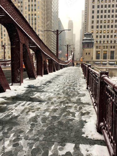 Footprints in the snow on LaSalle Street bridge during winter in Chicago.