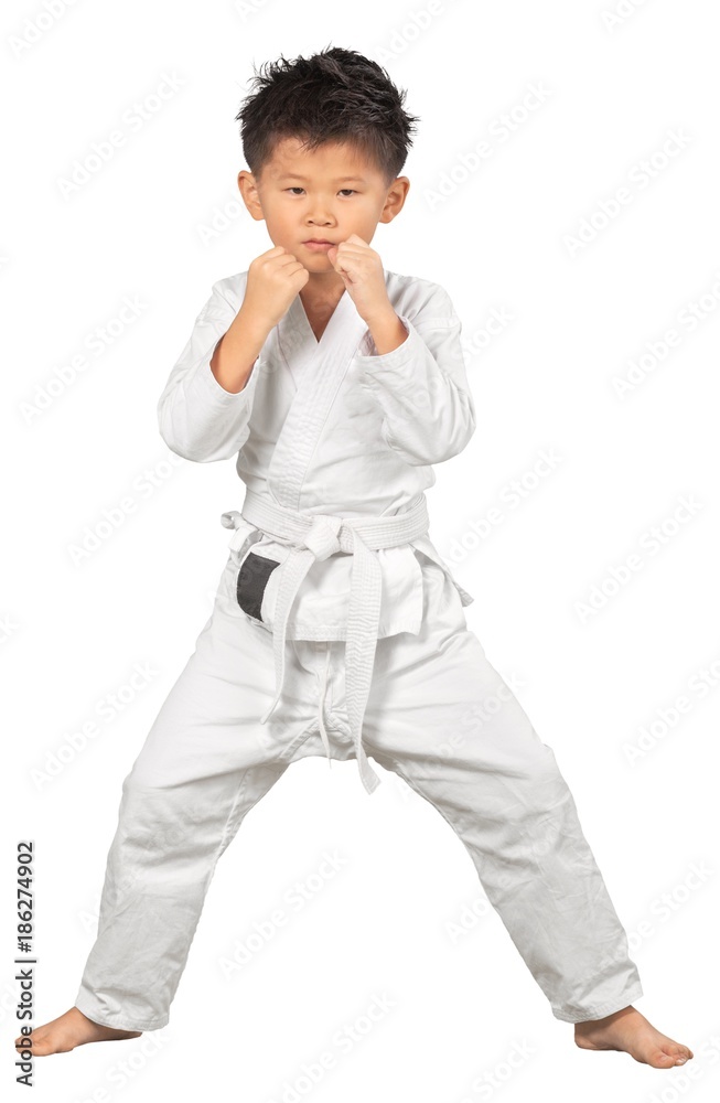 Asian Little Karate Boy in White Kimono on background Asian Little Karate Boy in White Kimono on background