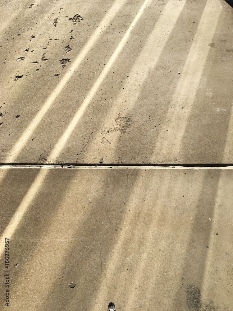 Light Reflections on A Concrete Sidewalk