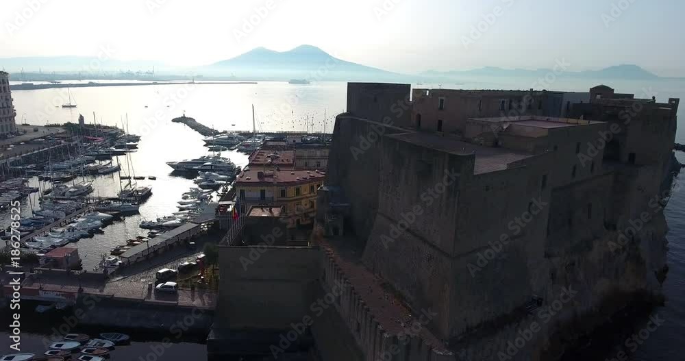 NAPLES, ITALY – JULY 2016 : Aerial shot over Castel Dell Ovo on a sunny day with harbor and boats in view