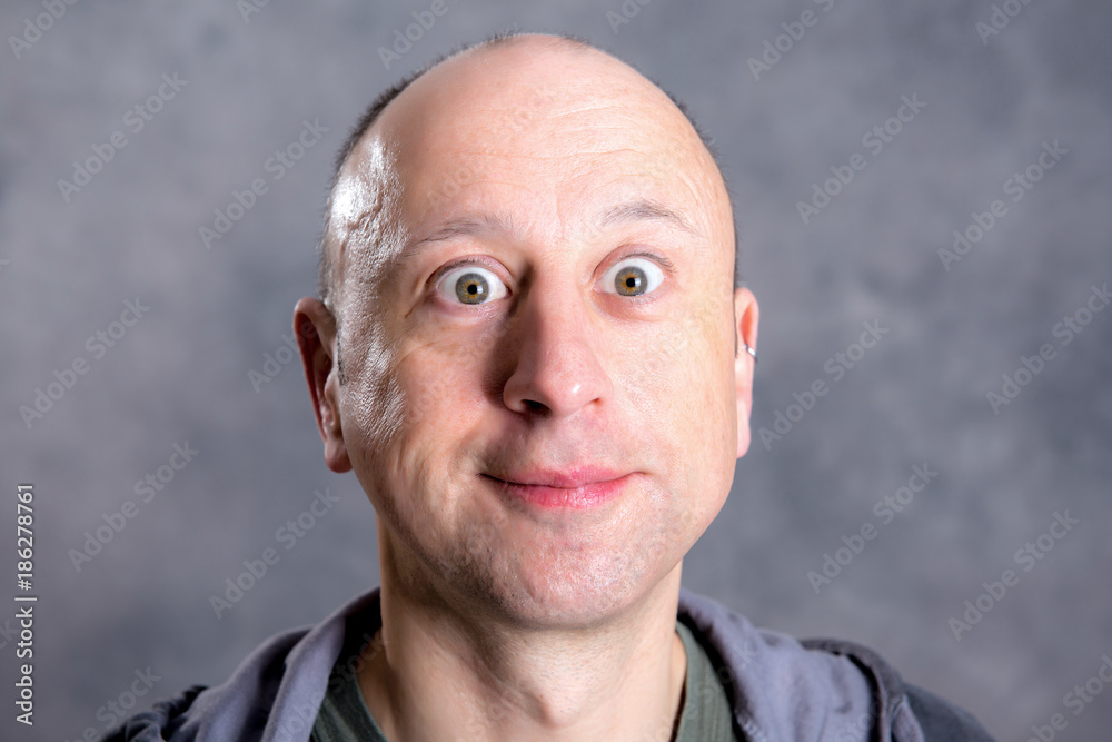 Fototapeta premium young man looking amazed in to the camera
