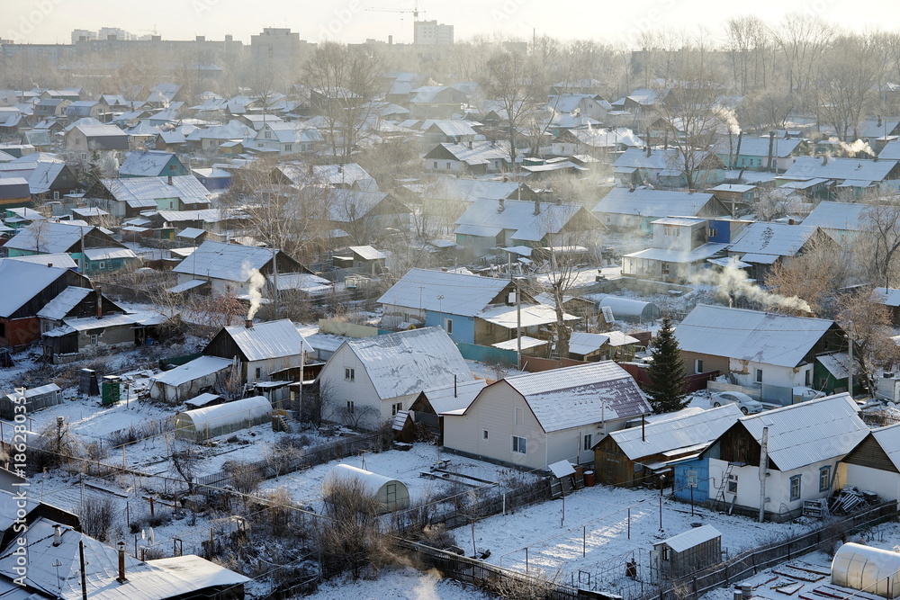Private residential sector on the outskirts of a big city in a frosty winter day. Novosibirsk Region, Russia.