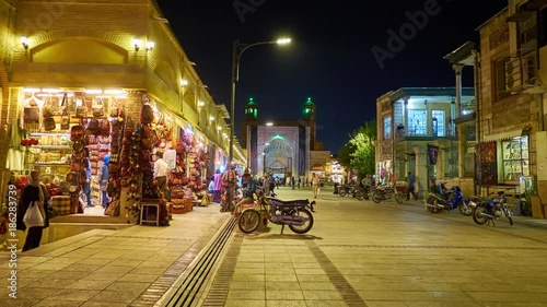 The evening in Vakil Bazaar, multiple shops are full of handicrafts and souvenirs, Vakil Mosque's iwan (portal) is seen on the background,  Shiraz