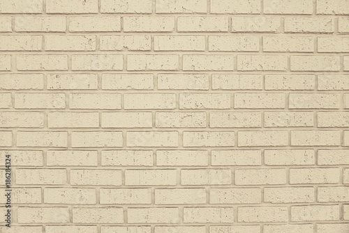 Old beige brick wall background texture