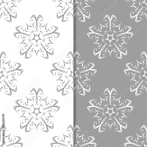 White and gray floral ornaments. Set of seamless backgrounds