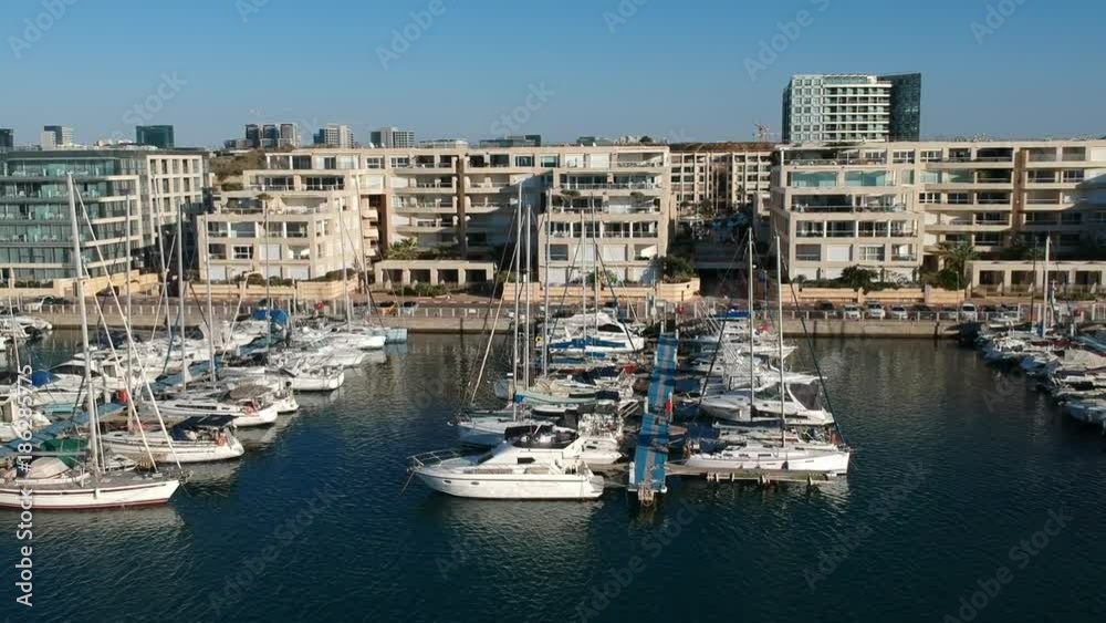 Fly shot of Herzliya Marina with yachts anchored and real estate zone Fly shot of Herzliya Marina with yachts anchored and real estate zone