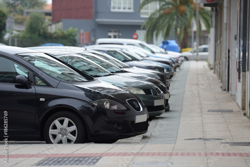 cars parked in a row on a city street