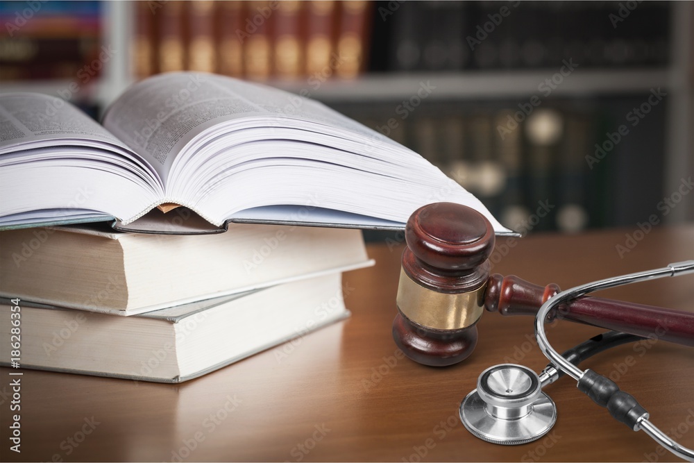 Stethoscope and gavel on table Stethoscope and gavel on table