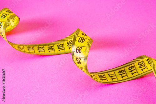 tape measure on pink background 