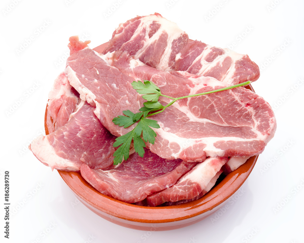 pork lean steaks in clay pot isolated on white background pork lean steaks in clay pot isolated on white background
