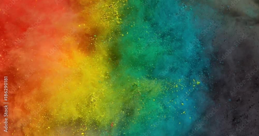 Colorful rainbow holi powder bounces off white canvas background in shockwave pattern of green blue pink and orange, slow motion, closeup
