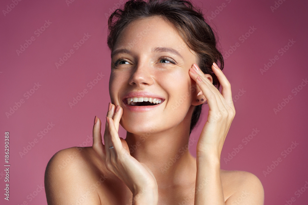 Young girl touching her healthy skin on pink background. Youth and skin care concept Young girl touching her healthy skin on pink background. Youth and skin care concept