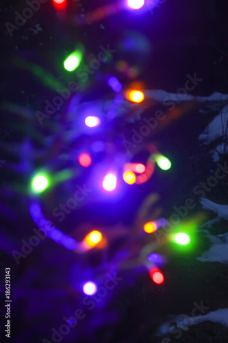 Festive New Year background with blurred colorful lights.