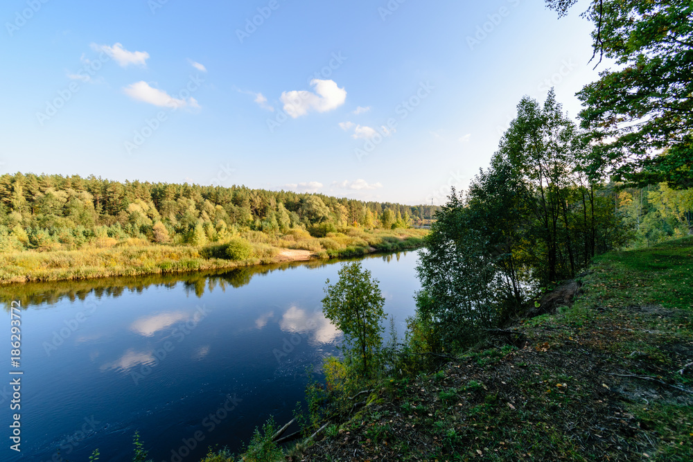 high water level in river Gauja, near Valmiera city in Latvia. summer trees surrounding high water level in river Gauja, near Valmiera city in Latvia. summer trees surrounding