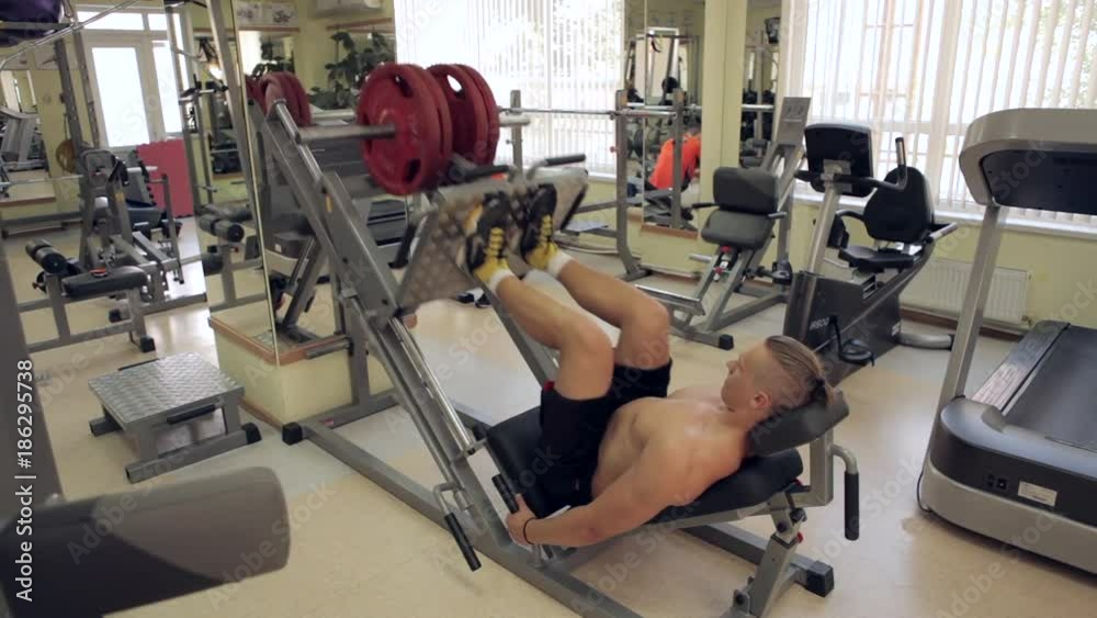 Men pushing weights in the gym Men pushing weights in the gym