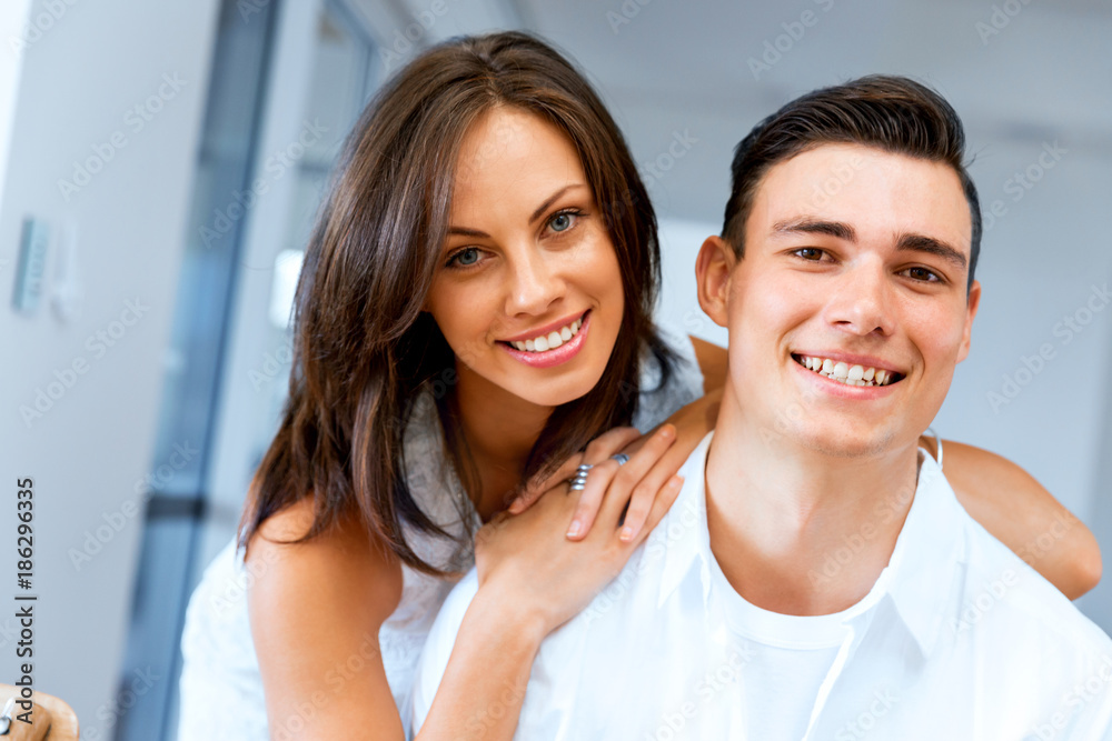 Smiling merry couple looking at camera Smiling merry couple looking at camera