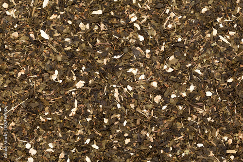 Organic Ginger Tulsi green tea. Macro closeup background texture. Top view.