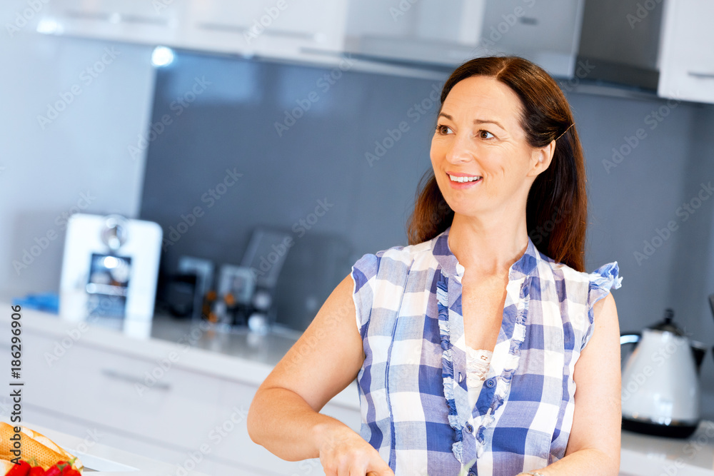 Beautiful woman standing in the kitchen Beautiful woman standing in the kitchen