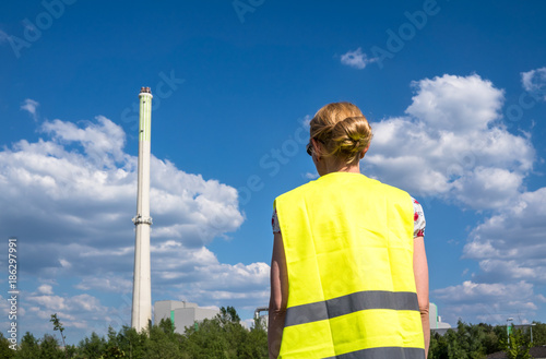 Lady observing the garbage incineration plant photo