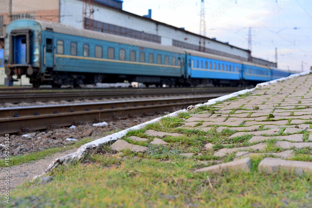 Fototapeta premium Passenger and freight train. Passenger diesel train traveling speed railway wagons journey light