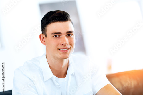 Portrait of a smart young man indoors photo