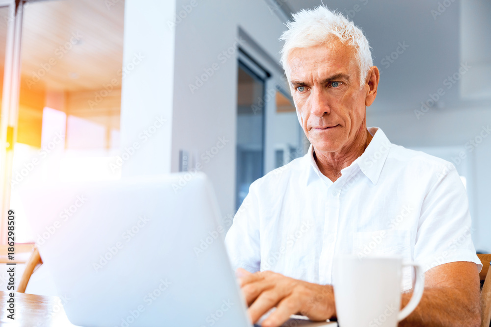 Man working on laptop at home Man working on laptop at home