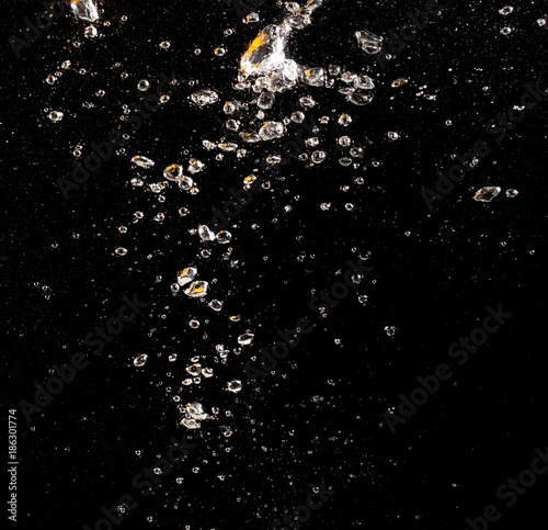 Bubbles under water on a black background