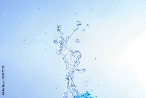 Bottle opening with water splashing isolated on white background.