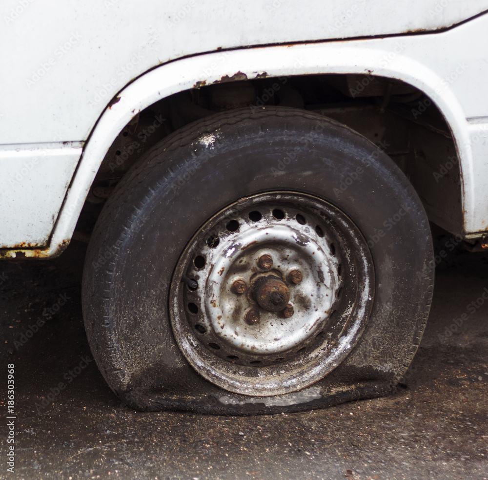 old car, the wheel could not stand the load and let go of old age, the color lost its freshness, abandoned car