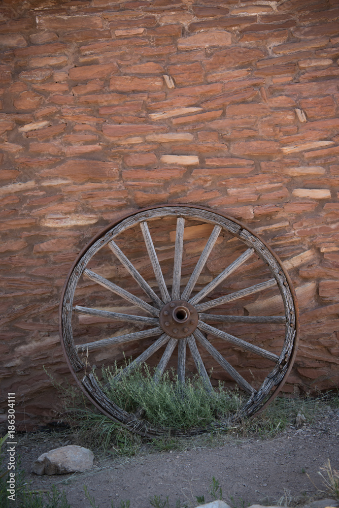 Wooden Wheel on Brick Wall Vertical