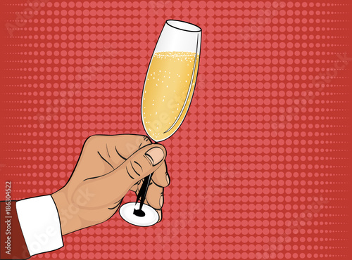 A hand holds a glass of champagne. Merry Christmas and a Happy N