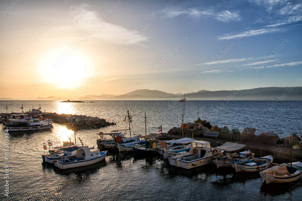 Sea sunset Fishing boats in the pictorial kamini port at Hydra island Greece