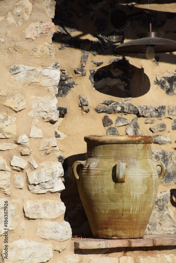 clay medieval jugs on a stone wall with free space for text clay medieval jugs on a stone wall with free space for text
