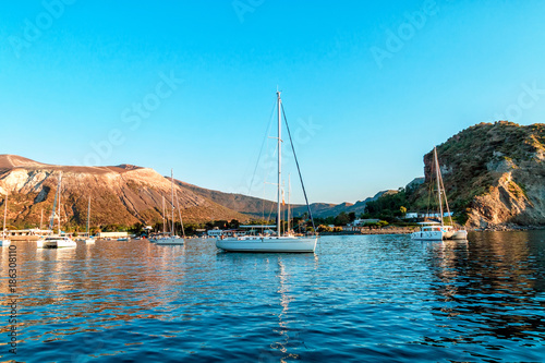 Sailing yachs and catamaran in the Gulf near Vulcano, Aeolian Islands, Tyrrhenian Sea, Sicily, Italy