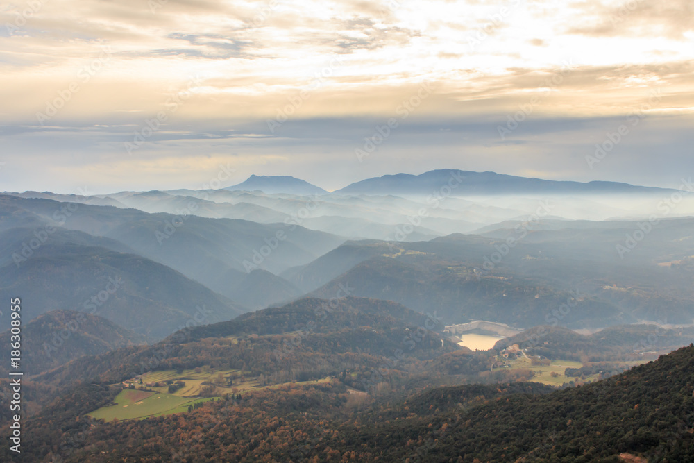 Fototapeta premium The mountains and the fog dream between them on the horizon