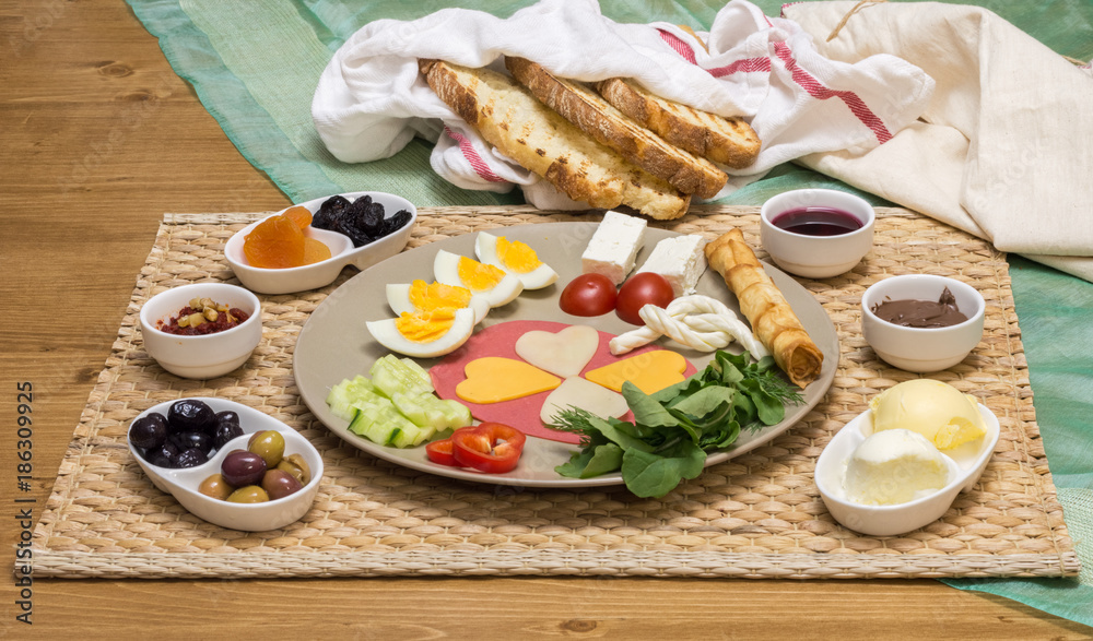 Close up of traditional Turkish breakfast served with cheese, salami, boiled egg, tomato, cucumber and toasted bread