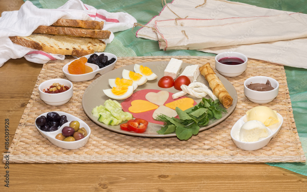 Close up of traditional Turkish breakfast served with cheese, salami, boiled egg, tomato, cucumber and toasted bread Close up of traditional Turkish breakfast served with cheese, salami, boiled egg, tomato, cucumber and toasted bread