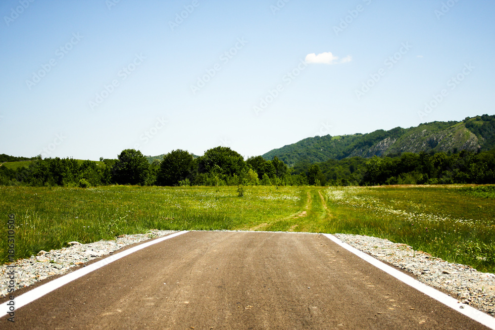 A paved road suddenly ending in the middle of nowhere