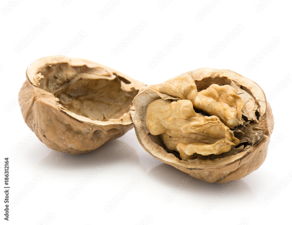 One shelled walnut with separated hollow half isolated on white background. One shelled walnut with separated hollow half isolated on white background.
