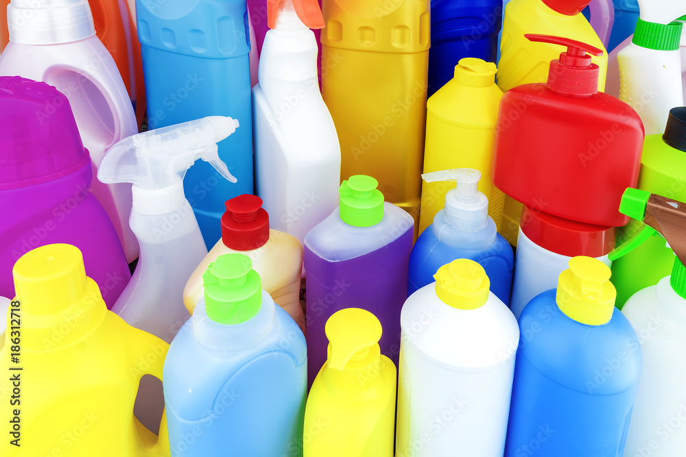 background of multi-colored bottles with household chemicals