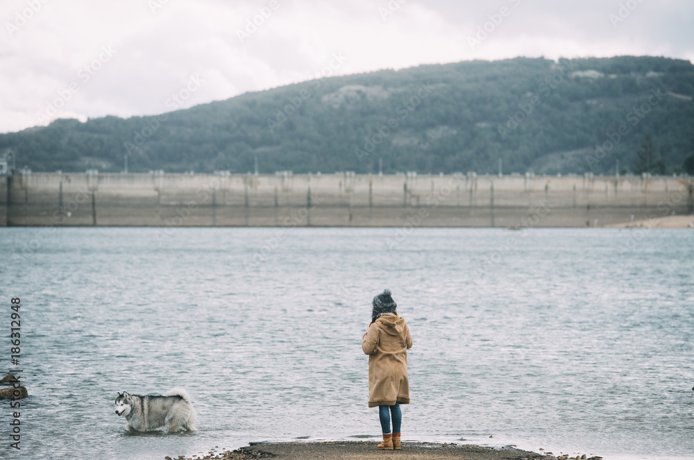 Girl standing in front of a lake Girl standing in front of a lake