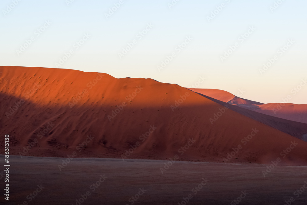 Detail view of red sand dunes in Sossusvlei near Sesriem in famous Namib Desert in Namibia, Africa. Sossusvlei is a popular tourist destination, the dunes are amongst the highest in the world.