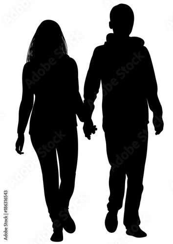 Silhouette of a girl and a young man walking alongside photo
