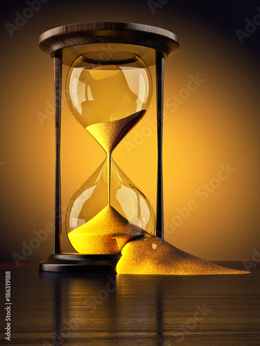 Wasting time concept, lack of time, time lost and time management, broken vintage hourglass with sand falling out of them, yellow background photo