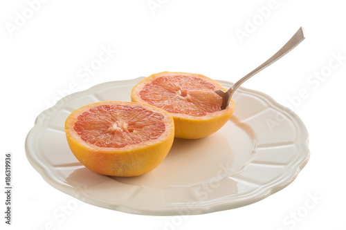Grapefruits on plate with spoon